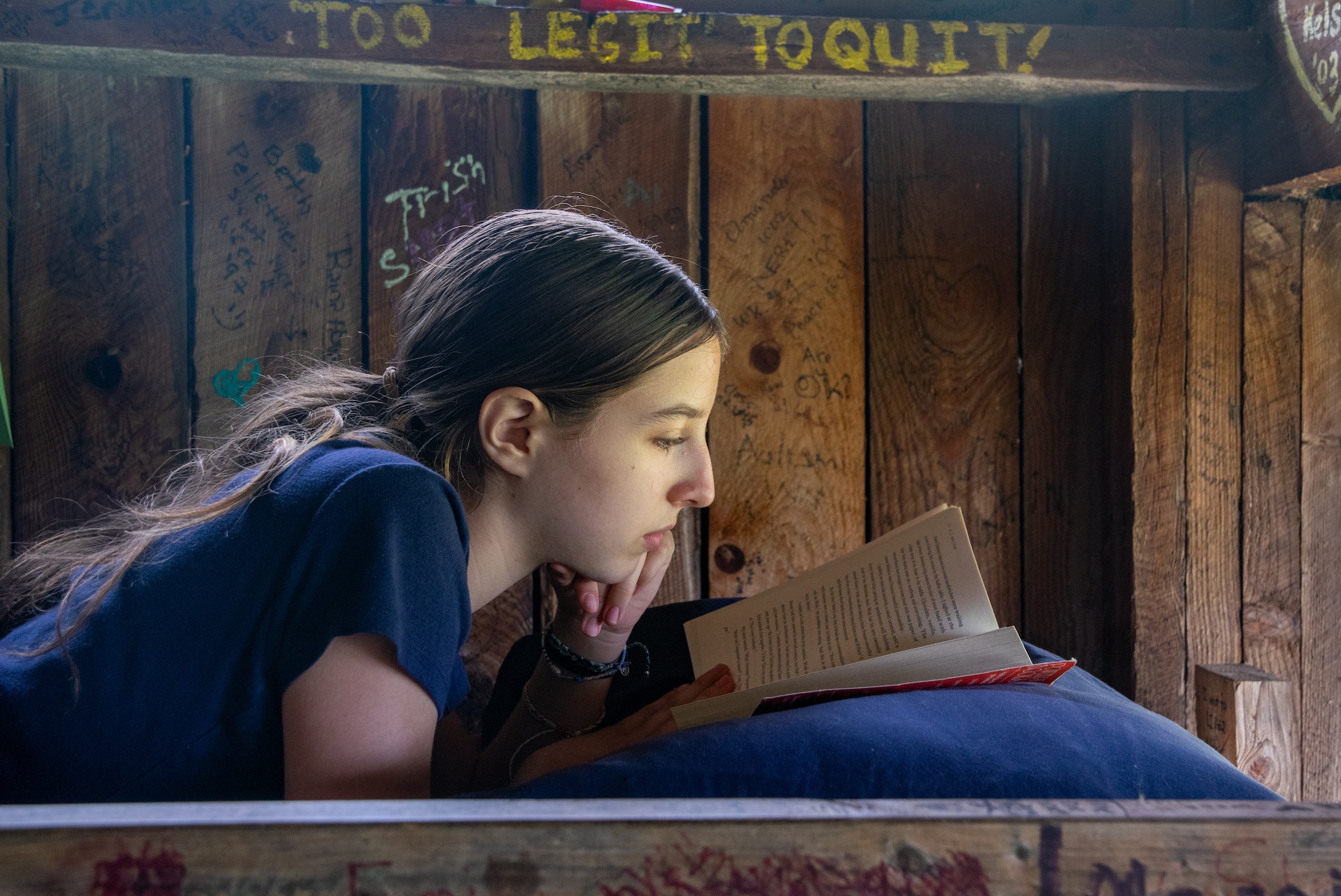 Girl reading on her bunk bed
